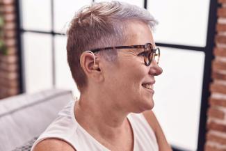 Middle-aged woman wearing a hearing aid.
