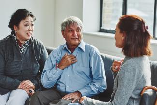 Older couple talking with care provider