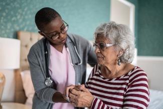 Clinician speaking to an older patient
